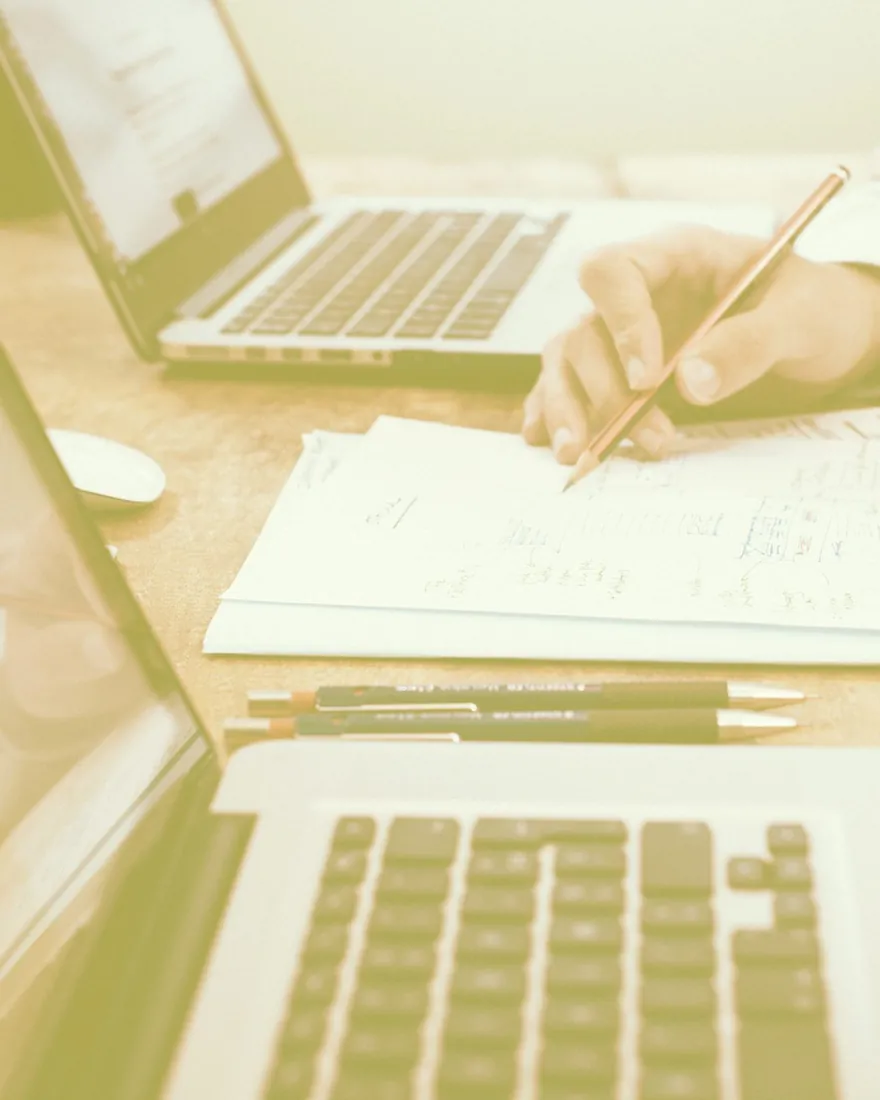 Working notes beside a laptop