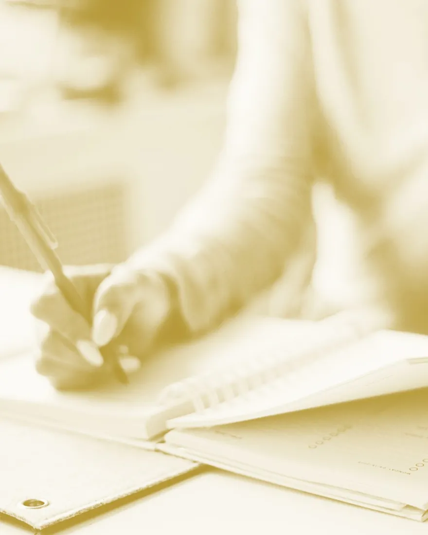 Notes being drafted by hand at a desk